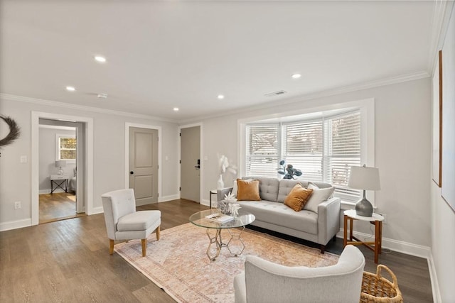 living room featuring hardwood / wood-style flooring and crown molding