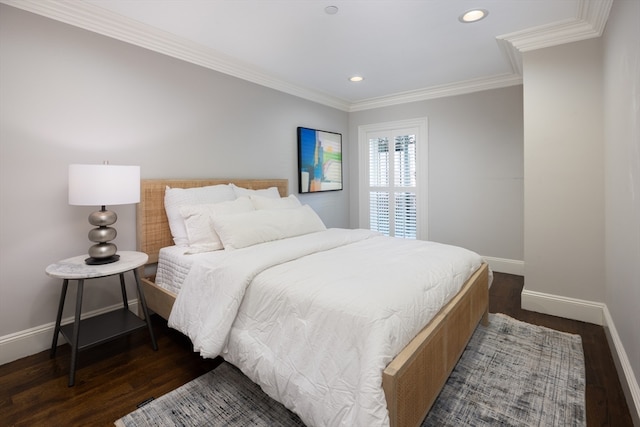 bedroom featuring crown molding and dark hardwood / wood-style floors