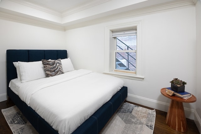 bedroom featuring ornamental molding and hardwood / wood-style floors