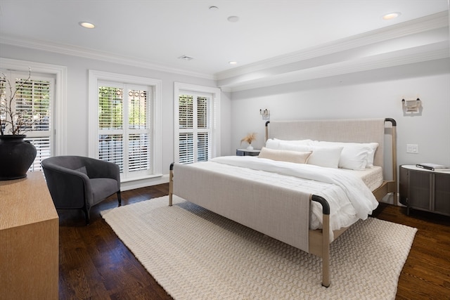 bedroom with ornamental molding and dark hardwood / wood-style floors