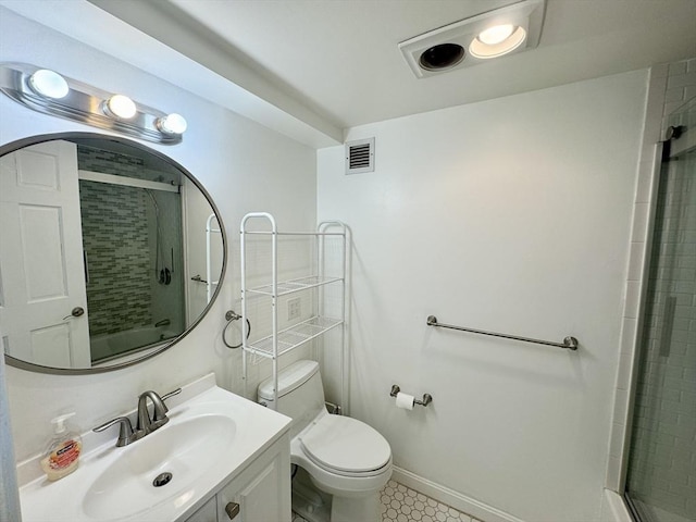 bathroom with visible vents, toilet, vanity, tiled shower, and baseboards