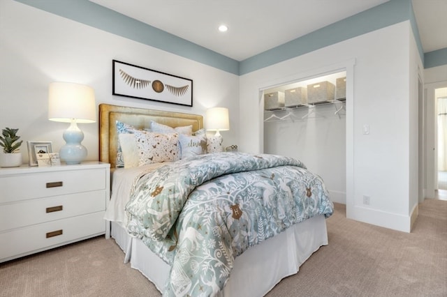 bedroom with light carpet, a closet, and a spacious closet