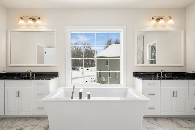 bathroom with vanity and a bath