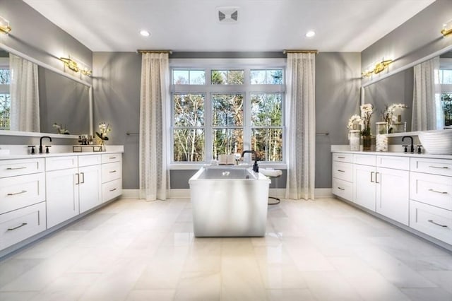 10 Old County Rd Unit 19, Hudson, MA 01749 - full bath featuring two vanities, healthy amount of natural light, a freestanding bath, and recessed lighting