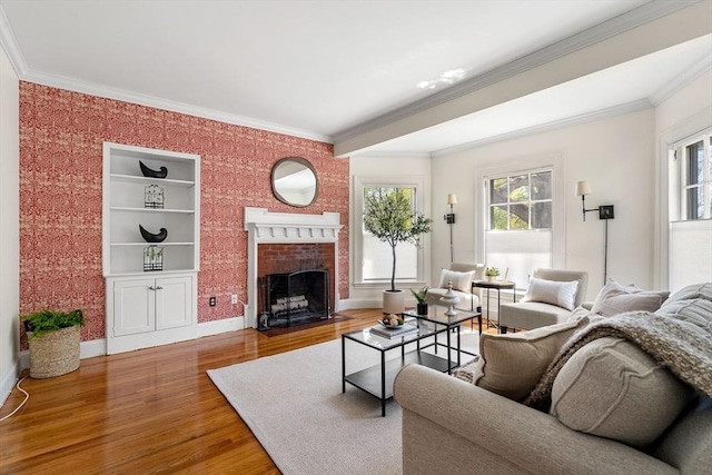 living room with ornamental molding, wood finished floors, and a fireplace