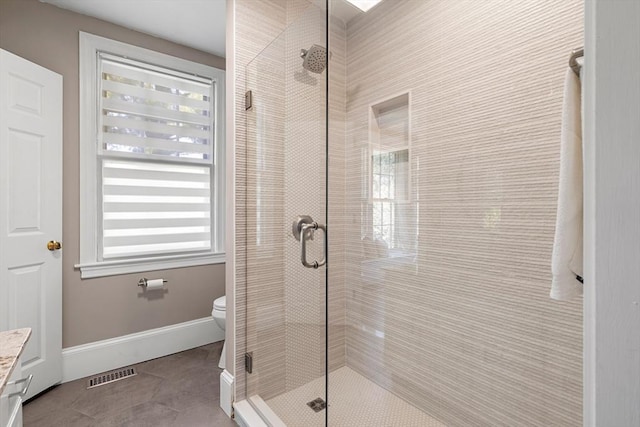 bathroom with toilet, visible vents, a shower stall, and tile patterned flooring