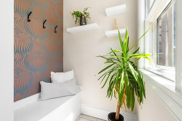 interior space with baseboards, plenty of natural light, and tile patterned flooring