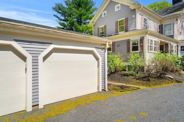view of side of property featuring an outdoor structure and a garage