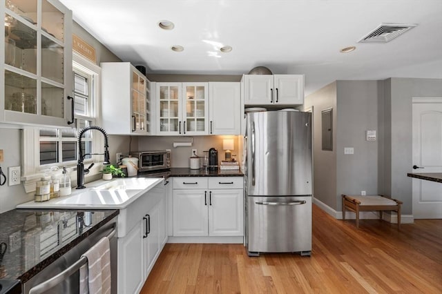 2 Hawthorne Blvd Unit 4, Salem, MA 01970 - kitchen with freestanding refrigerator, electric panel, light wood finished floors, white cabinets, and recessed lighting