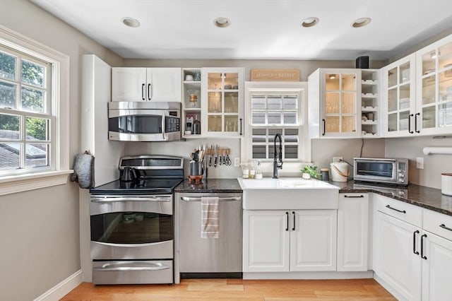 2 Hawthorne Blvd Unit 4, Salem, MA 01970 - kitchen with stainless steel appliances, open shelves, white cabinetry, and recessed lighting