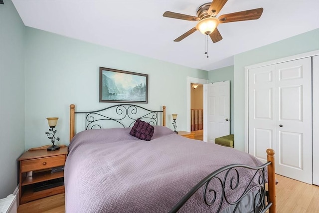 bedroom featuring a closet, light wood-style flooring, and ceiling fan