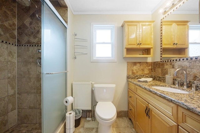 full bath featuring radiator, plenty of natural light, toilet, a shower stall, and crown molding