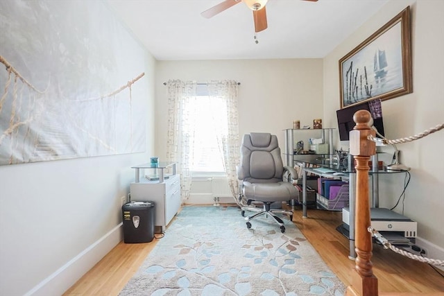 office area featuring wood finished floors, ceiling fan, and baseboards