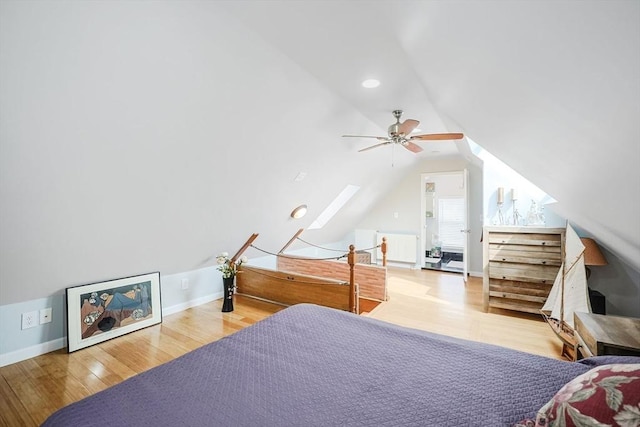 bedroom featuring wood finished floors, lofted ceiling, baseboards, and a ceiling fan