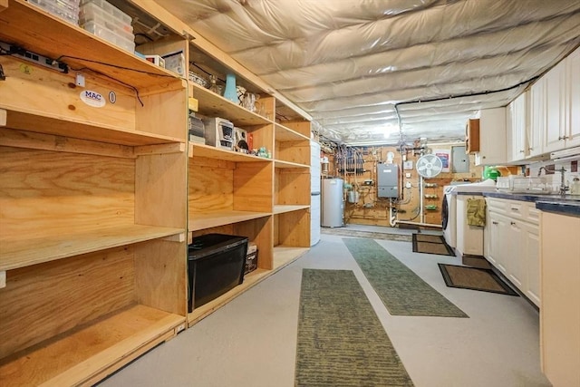 storage area featuring washer / clothes dryer and gas water heater
