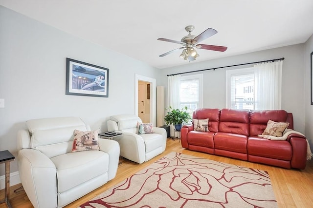 living area with ceiling fan and light wood-type flooring