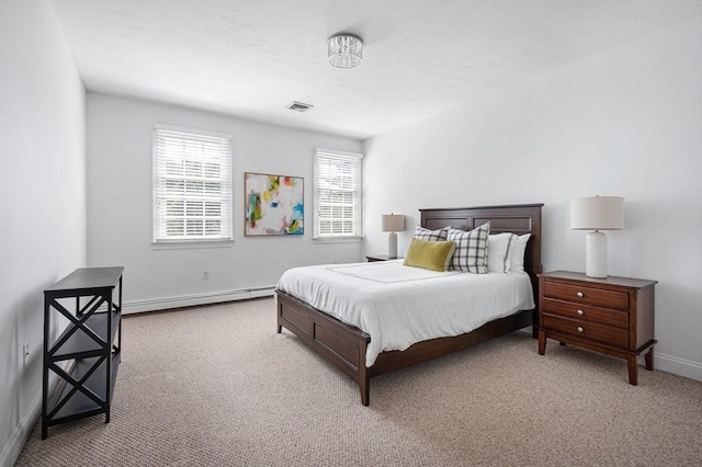 bedroom with baseboard heating, baseboards, carpet flooring, and visible vents