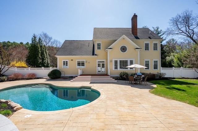 view of swimming pool featuring a fenced backyard, a yard, a patio area, and a fenced in pool