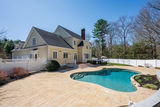 view of pool with a fenced in pool, a fenced backyard, and a patio