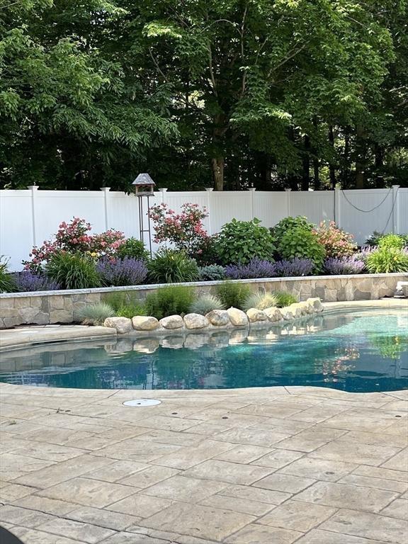 view of swimming pool with a fenced backyard and a fenced in pool