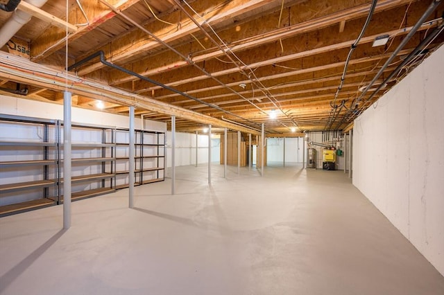unfinished below grade area featuring water heater and a heating unit