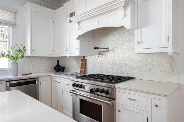 kitchen featuring light countertops, backsplash, white cabinets, and stainless steel appliances