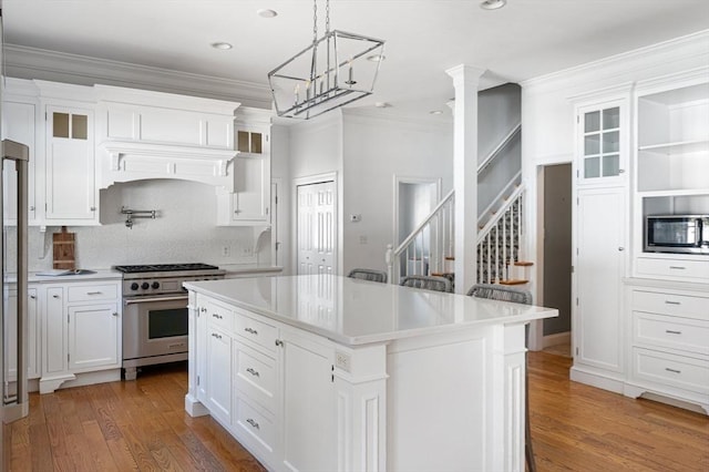 kitchen featuring appliances with stainless steel finishes, crown molding, and white cabinetry