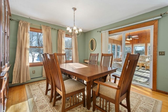 dining space featuring an inviting chandelier and light hardwood / wood-style floors