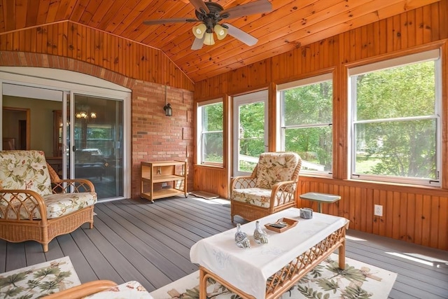 sunroom / solarium featuring lofted ceiling, wooden ceiling, and ceiling fan