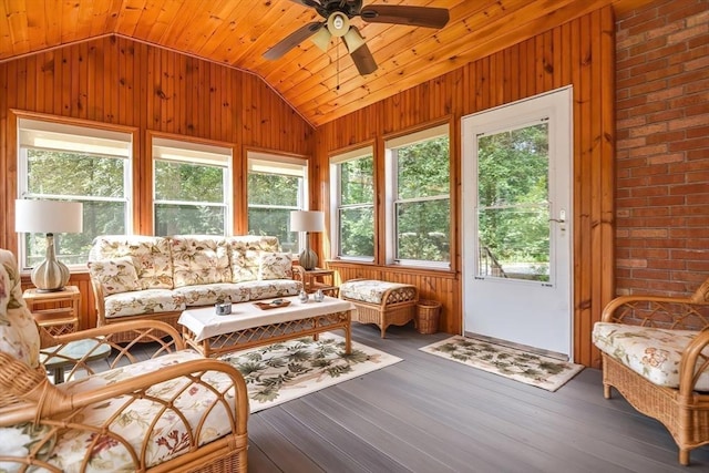 sunroom with ceiling fan, wood ceiling, vaulted ceiling, and a healthy amount of sunlight