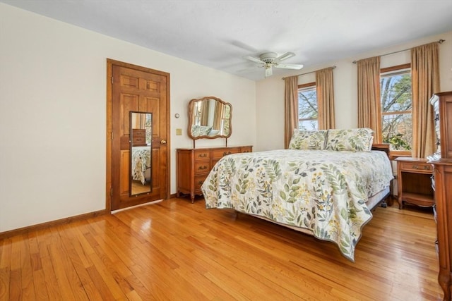 bedroom with light hardwood / wood-style floors and ceiling fan