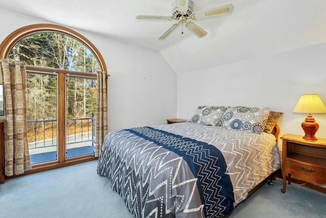 carpeted bedroom with ceiling fan, vaulted ceiling, and access to outside