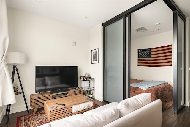 living area with dark wood finished floors and baseboards