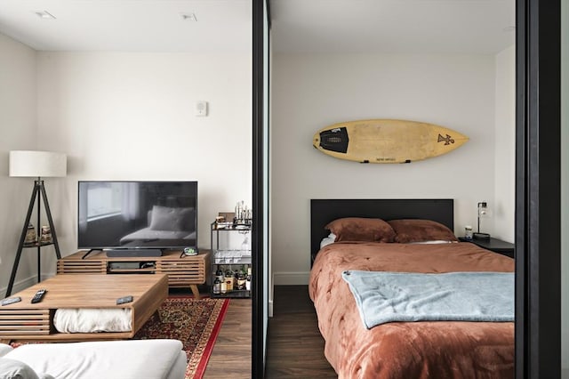 bedroom featuring wood finished floors and baseboards