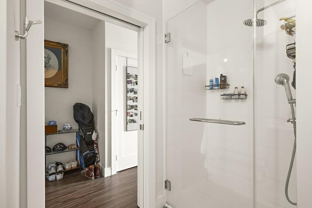 bathroom featuring a shower stall and wood finished floors