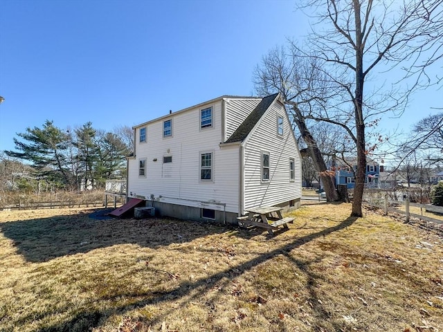 back of property with cooling unit and a lawn