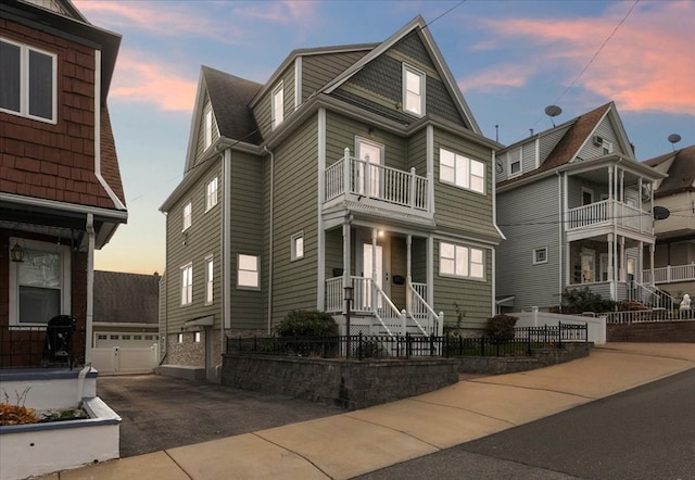 view of front of home featuring a balcony and a garage