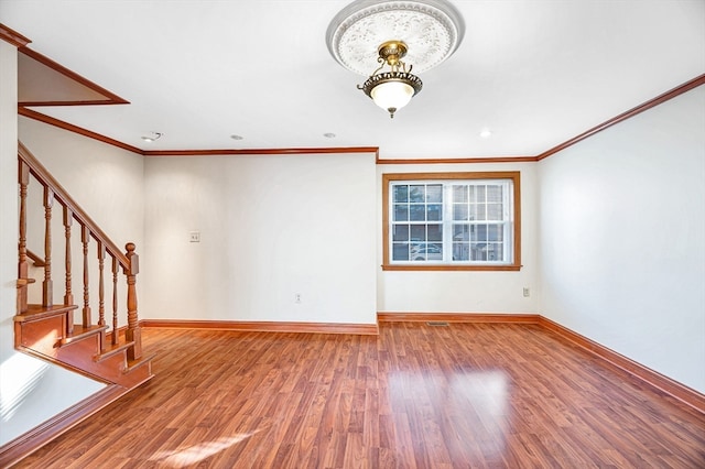 unfurnished living room with wood-type flooring and ornamental molding