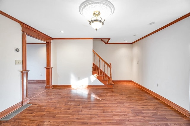 unfurnished room featuring hardwood / wood-style flooring and crown molding