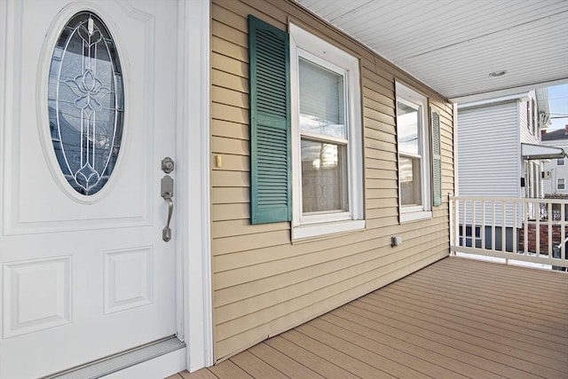 view of exterior entry featuring covered porch