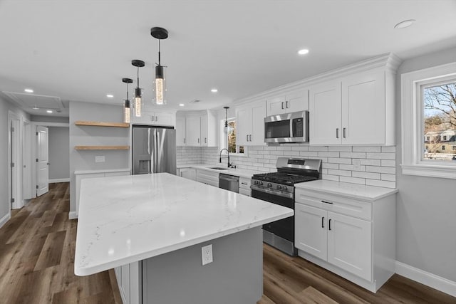 kitchen with sink, a center island, white cabinets, and appliances with stainless steel finishes