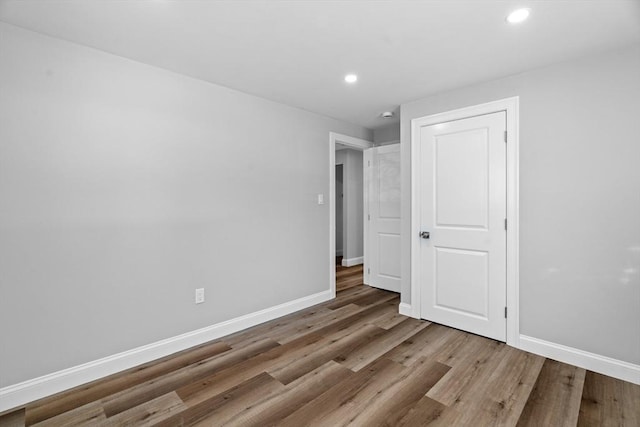 unfurnished bedroom with wood-type flooring