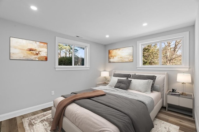 bedroom with hardwood / wood-style flooring