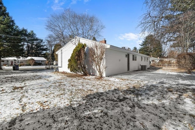 view of snowy exterior featuring cooling unit