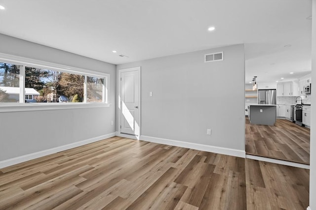 empty room with light wood-type flooring