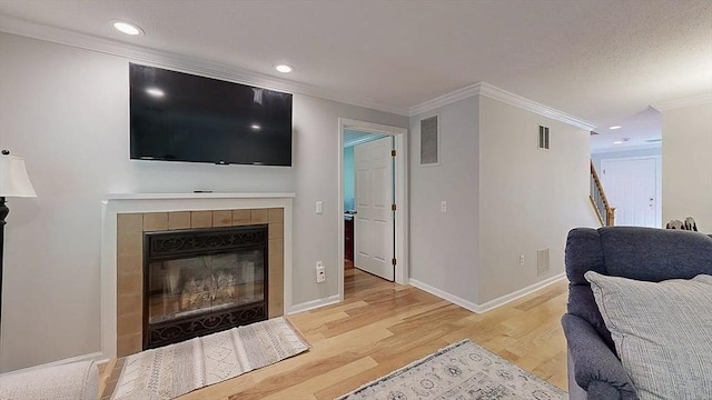 3 Oakwood Ln Unit 3, Worcester, MA 01604 - living area with wood finished floors, ornamental molding, a tile fireplace, and recessed lighting
