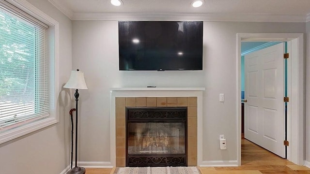 3 Oakwood Ln Unit 3, Worcester, MA 01604 - detailed view of wood finished floors, crown molding, a tile fireplace, and recessed lighting
