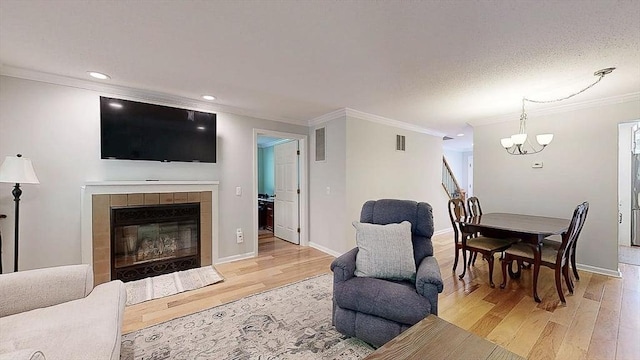 3 Oakwood Ln Unit 3, Worcester, MA 01604 - living area featuring crown molding, light wood-style floors, a chandelier, a fireplace, and recessed lighting