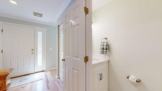3 Oakwood Ln Unit 3, Worcester, MA 01604 - entryway with crown molding, light wood-type flooring, and a textured ceiling