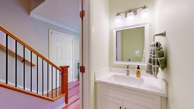 3 Oakwood Ln Unit 3, Worcester, MA 01604 - bathroom featuring ornamental molding, vanity, wood finished floors, and a textured ceiling